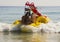 Holiday makers in hired Pedalos fight against the incoming surf to get out into calmer water at the beach in Albuferia Portugal