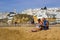 Holiday makers relaxing in the sun on the beach at the Old Townin Albuferia, Portugal