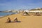 Holiday makers relaxing in the sun on the Praia Azul beach in Albuferia, Portugal