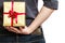 Holiday. Man hiding surprise gift box behind back