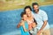 Holiday, ocean and outdoor portrait of family with smile, nature and bonding together on travel adventure. Mom, dad and