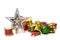 Holiday ornaments of a Christmas tree: silver star, glittery balls, gift boxes, bells, and drums