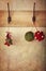 Holiday ornaments hanging on antique wall hooks