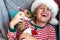 Holiday Pets Christmas guinea pig Cute boy hugs his pets guinea pig Boy in red Santa Hat