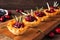 Holiday phyllo pastry appetizers with cranberries and baked brie. Side view serving board against wood.