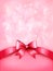 Holiday pink background with gift glossy bow