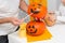 Holiday preparation and handmade party decor. Halloween family indoor activity, pumpkin painting process
