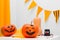 Holiday preparation and handmade party decor. Halloween indoor activity, pumpkin painting.