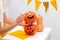 Holiday preparation and handmade party decor. Halloween indoor activity, pumpkin painting process