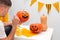 Holiday preparation and handmade party decor. Halloween indoor activity, pumpkin painting process