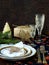 Holiday rustic Christmas and New Year table setting with xmas decorations at dark wooden table. Selective focus,