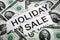 Holiday on sale signs with some $2 dollar bills