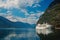 Holiday ship in sea port on mountain landscape in Flam, Norway. Ocean liner in sea harbor with green mountains. Cruise