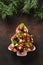 Holiday snacks as canapes in shape of Christmas tree plate for festive Xmas party