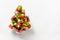 Holiday snacks as canapes in shape of Christmas tree plate for festive Xmas party