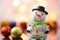 Holiday snowman with Christmas tree bulbs on a bokeh background