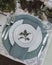 Holiday Summer or early autumn outside table setting with linen napkins and green leaves. Close up