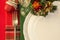 Holiday table setting with Christmas decorations over colorful napkins.