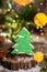 Holiday traditional food bakery. Gingerbread green christmas tree in cozy warm decoration with garland lights