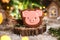 Holiday traditional food bakery. Gingerbread pink pig head in cozy warm decoration with garland lights