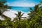 Holiday vacation at Petite Anse paradise beach framed by green foliage. La Digue island, Seychelles