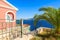 Holiday villas and palm tree on coast of Kefalonia island in Agia Efimia village, Greece