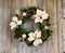 Holiday white Poinsettia Christmas wreath on rustic cedar wooden