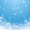 Holiday winter background for Merry Christmas and Happy New Year. Falling white snowflakes on blue background. Winter blue sky