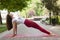 Holiday woman doing yoga pose meditation in the public park Sport Healthy concept