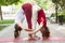 Holiday woman doing yoga pose meditation in the public park Sport Healthy concept