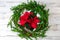 Holiday wreath and pointsettia on white shiplap background