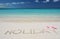 HOLIDAY writing on the sandy beach