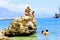 Holidaymakers sunbathe on a huge rock in the sea Alanya, Turkey
