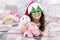 Holidays atmosphere. Christmas spirit. New year holiday. Small child wear santa hat celebrate new year at home decorated