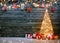 Holidays background with illuminated Christmas tree, gifts and d