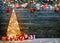 Holidays background with illuminated Christmas tree, gifts and decoration
