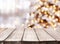 Holidays background with light spots, bokeh and vintage wooden tabletop