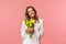 Holidays, beauty and spring concept. Portrait of lovely caucasian blond girl in white dress, smiling upbeat, holding