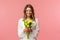 Holidays, beauty and spring concept. Portrait of lovely, romantic blonde girl in white dress, holding yellow tulips