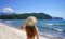 Holidays in Brazil. Back view of bikini girl walking on Ubatuba tropical beach, Brazil