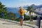 Holidays in Brazil. Full length view of tourist girl looking at Rio de Janeiro cityscape with Copacabana beach, Rio de Janeiro,