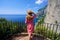 Holidays in Capri, Italy. Young fashion woman enjoying landscape from balcony in Capri Island, Italy