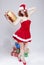 Holidays Concept and Ideas. Happy Smiling Caucasian Red Haired Santa Helper Holding Golden Gift in Hand