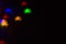 holidays, decoration and party concept - defocused bokeh multicolor lights in shape of spiders for halloween background. copy spac