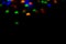 holidays, decoration and party concept - defocused bokeh multicolor lights in shape of spiders for halloween background. copy spac