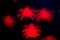 holidays, decoration and party concept - defocused red spiders silhouette on black for halloween background