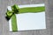Holidays gift card with green bow