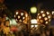 Holidays illumination, electric street lamp decorated with carved pumpkins. Traditional symbol for harvest holidays