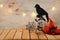 Holidays image of Halloween. bats, black crow and witch hat over wooden table