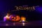 Holidays image of halloween. Pumpkins over wooden table dark background
